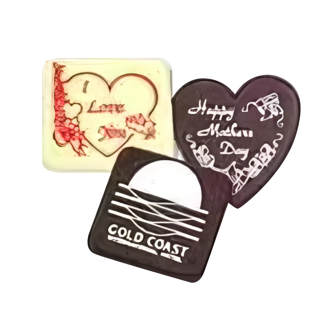 Three 50mm x 50mm x 6mm Square Chocolates come with sweet messages: white chocolate with I Love You, a black heart with Mothers Day, and a black square featuring the Cold Coast logo, all elegantly decorated in red or white icing.