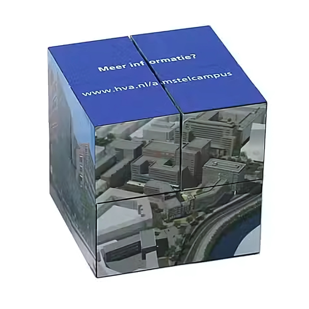 The Magic Folding Cube 6cm features an aerial view of buildings with a river. Its top face is blue, displaying white text: Meer informatie? alongside the URL www.hva.nl/amstelcampus.