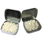 Two promotional open tins of Musk Mint on a white background.