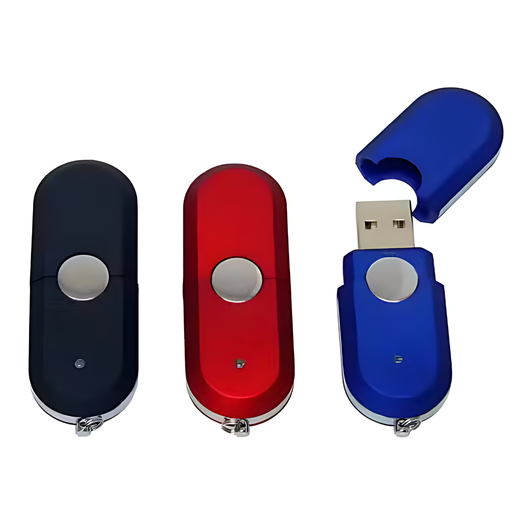 The Capsule USB flash drives in black, red, and blue are lined up, with the blue drive on the right showing its exposed USB connector after removing the cap. Each drive features a central circular button.
