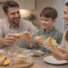Family enjoying Australian Made Fortune Cookies together at the dining table in a cozy kitchen.