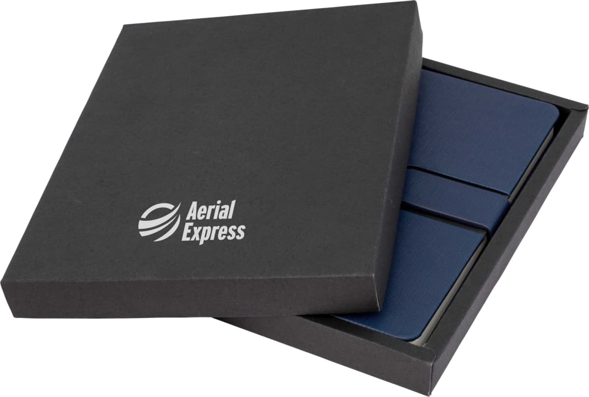A dark gray box with the logo Aerial Express is partially open, revealing three stacked, dark blue notebooks inside.