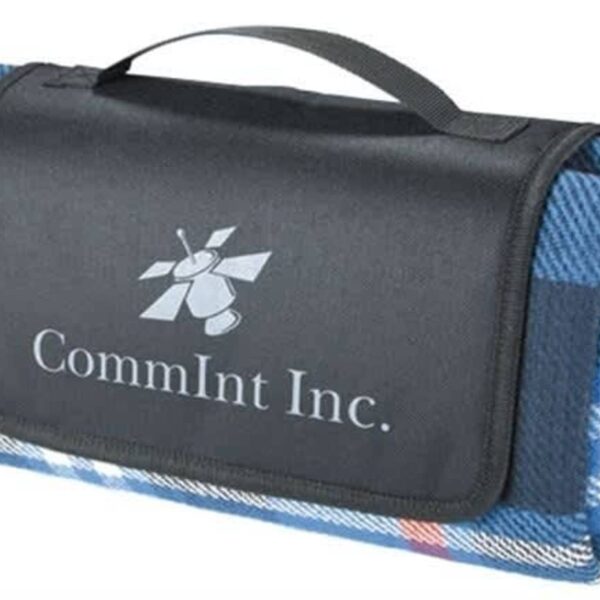 Folded blanket with a blue plaid pattern and a black flap, featuring the logo and text CommInt Inc. on the front. It has a black handle for easy carrying.
