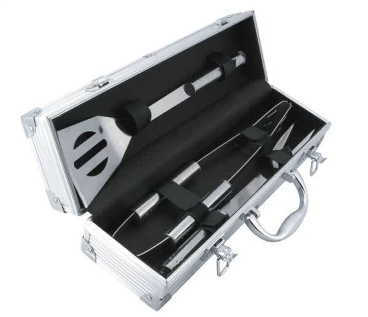 A silver metal case containing stainless steel barbecue utensils, including a spatula, tongs, and a fork, neatly secured with black straps. The case has a handle and latches.