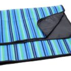 A folded blanket with blue, green, and black stripes. The blanket has a black backing, visible at the corner where it is slightly turned over.