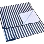 A folded picnic blanket with black and white stripes.