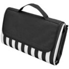 A portable picnic blanket folded into a compact, purse-like shape with a handle. It features a black flap covering a black-and-white striped design. Perfect for outdoor use.