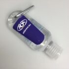 Clear bottle of hand sanitizer with a carabiner and an ADA label on a white background.