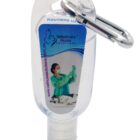 clear hand sanitizer bottle with a purple label featuring the text donate life and a heart made of arrows. It has a metal clip attached to the top. The background is black and white.||A clear hand sanitizer bottle with a metal clip at the top. The label displays a person in a green gown examining a dog. The text on the label reads Veterinary Nurse Solutions along with a website URL.||A transparent hand sanitizer bottle with a blue label featuring a gold logo and the text MAXIRON. The bottle has a flip-top cap