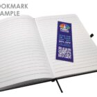 Open notebook with a blue bookmark displaying NBC logo and QR code.