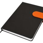 Black notebook with an orange clasp, closed and lying flat.