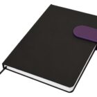 Black notebook with a purple clasp laying closed on a white background.