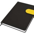 Black notebook with a yellow clasp and a ribbon bookmark visible.