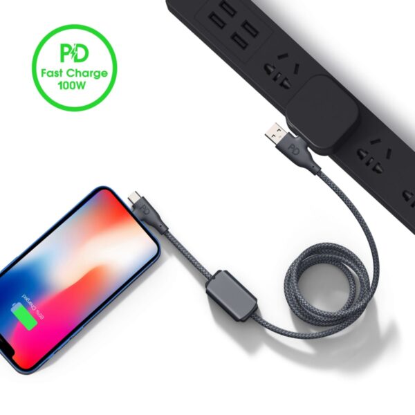 Coiled charging cable connecting a phone and power strip, with a PD Fast Charge 100W logo.
