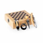 Wooden chessboard box with wine bottle stopper, corkscrew, ring, and pourer beside it.