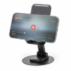 Smartphone on a black adjustable stand displaying a paused video screen.