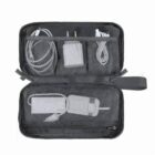 A black travel pouch with chargers and cables organized in mesh compartments.