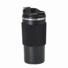 Black travel mug with ribbed grip and flip-top lid on a white background.