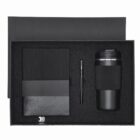 Black gift set with notebook, pen, thermos, and USB drive in black box.