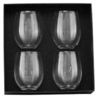 Four stemless wine glasses arranged in a black foam-lined box.