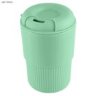 Light green, reusable coffee cup with a lid and ribbed lower section.