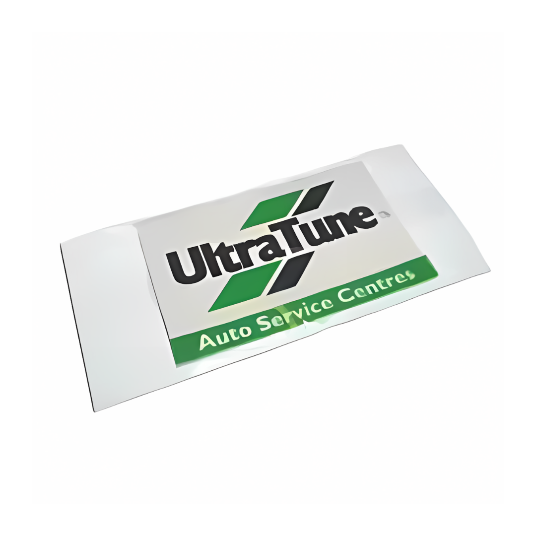 The Air Freshner comes in a white packet with the UltraTune logo in bold black text and a stylized green X. Below, Auto Service Centres is featured in vibrant green, symbolizing freshness and quality.