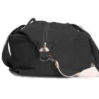 A black duffel bag with a zipper and a detachable white shoulder strap.