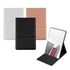 Three foldable pocket mirrors in black, white, and pink; one is open showing its reflection.