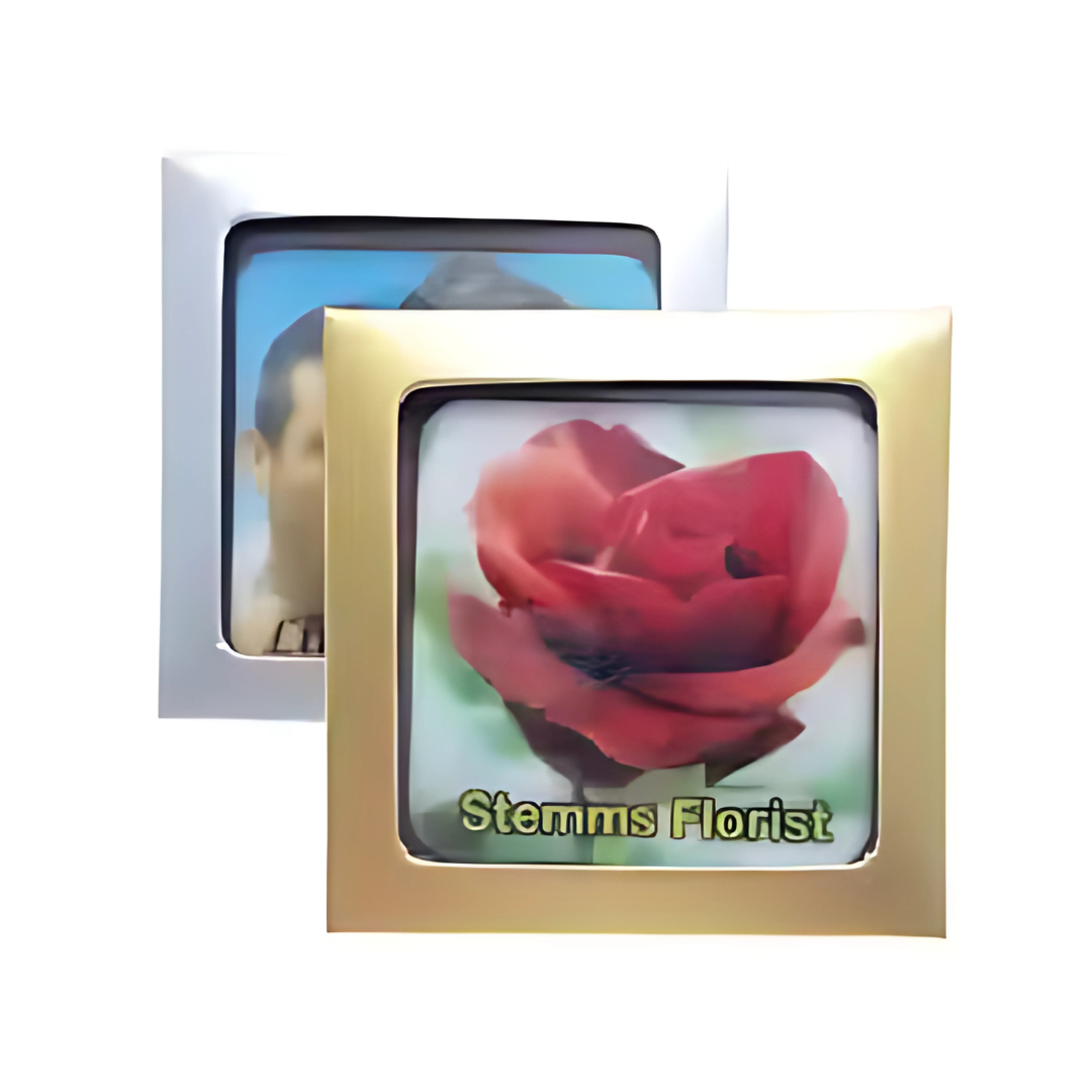 A close-up displays two framed images: the front gold frame features a large red rose with the text Stemms Florist, while the background silver frame shows a blurred image of someone holding Corporate chocolates Colour Mini Square Boxed, ideal for corporate gifts.