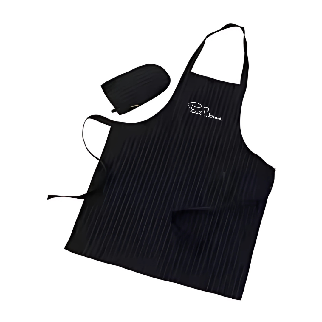The Corporate Gift PAUL BOCUSE APRON GLOVE SET, an elegant black ensemble with white pinstripes, makes a perfect stylish gift. It includes an apron with a neck loop, waist ties, and pocket, and a matching oven mitt. Paul Bocuse is embroidered in white on the chest.