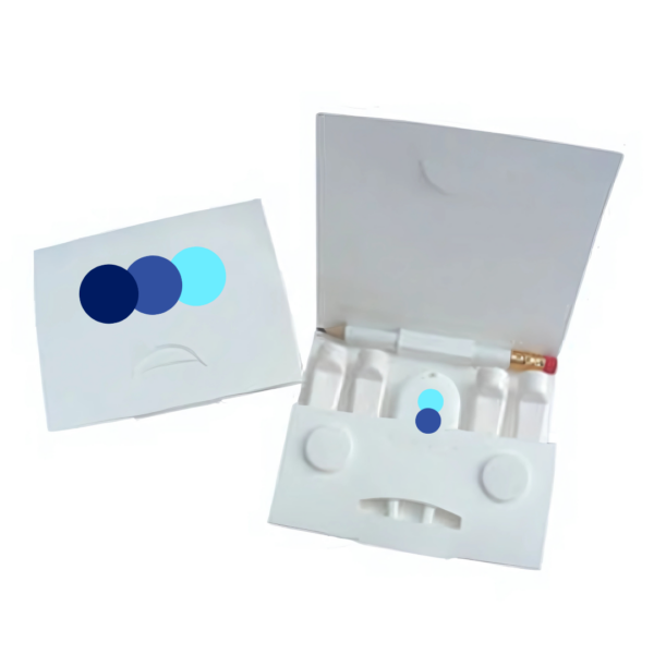 A white cardboard package is open, showcasing a pencil and four pastel sticks inside. The lid displays three overlapping blue circles, similar to a corporate logo. Inside are circular compartments and slots for the items. (Product: Corporate Golf Wedge Tee).