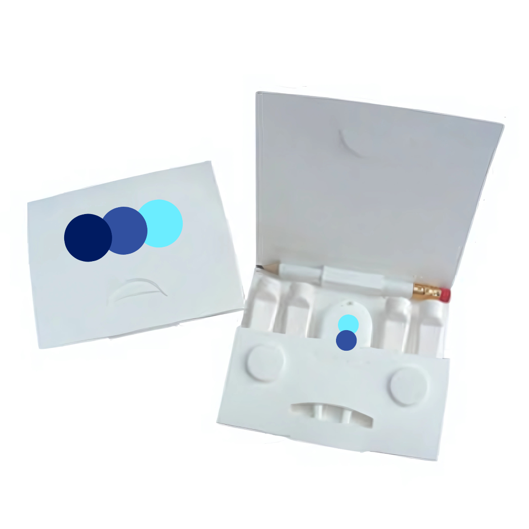 A white cardboard package is open, showcasing a pencil and four pastel sticks inside. The lid displays three overlapping blue circles, similar to a corporate logo. Inside are circular compartments and slots for the items. (Product: Corporate Golf Wedge Tee).