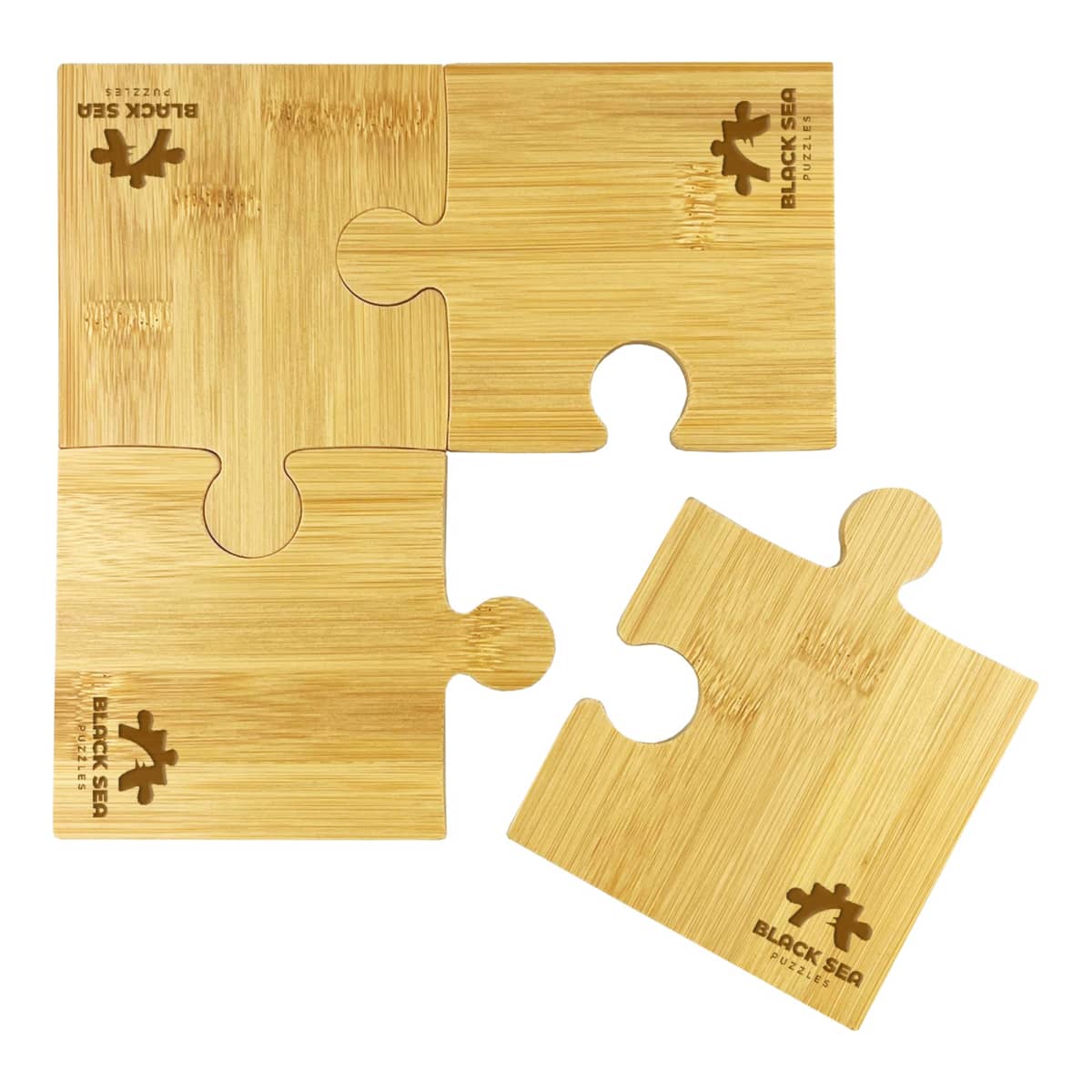 A set of four brown wooden puzzle pieces, one separated from the rest. Each piece features a turtle and the words BLACK SEA engraved on them.