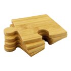 A stack of four wooden coasters shaped like puzzle pieces, resting on a white background.