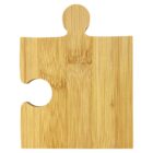 A single wooden puzzle piece made of bamboo with a natural finish. The piece has a protruding round top and an indentation on the left side, showing its interlocking design.