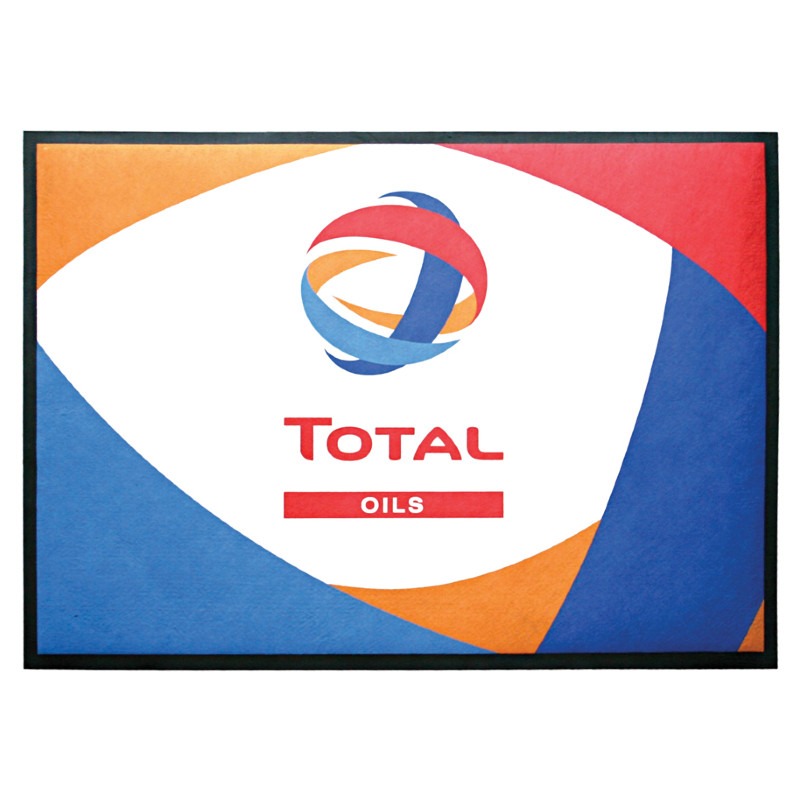 A colorful mat with a logo featuring red, blue, and orange curves surrounding a circle. Below the logo, the words TOTAL and OILS are written in red on a white background with orange and blue sections.
