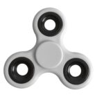 White fidget spinner with three black bearings on a plain white background.