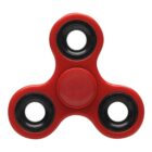 Red three-pronged fidget spinner with black bearings on a white background.