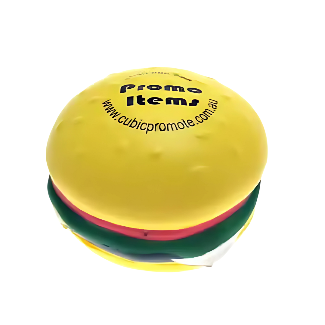 The Funky Stress Ball Hamburger, in vibrant yellow, features Promo Item and a website URL on the top bun. With layers of lettuce, tomato, and a visible patty, its not just your average stress ball—its wildly fun!.