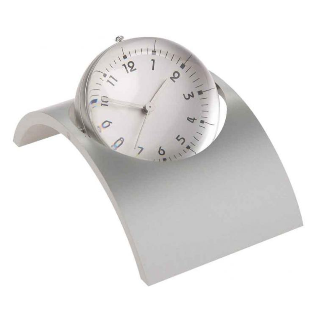 The Globe Arch Clock features a round, silver frame and minimalist white face with black numbers. It rests on an elegant, arch-shaped silver base, adding a contemporary touch to any space.