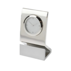 Introducing the Milano Clock: a sleek desk clock featuring a minimalist design with a polished silver finish. It has a round face, thin black hour and minute hands, and an angled rectangular base for added sophistication and style.