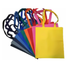 The Non-woven Tote 38x42cm wGusset Local collection displays a vibrant fan of bags in bright yellow, pink, red, orange, blue, and black with matching handles and spacious gussets for functionality.
