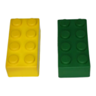 Two oversized Stress Shaped Building Blocks, one yellow and one green, each with eight studs on top, are shown side by side against a plain white background. Their simple design offers a playful stress escape.