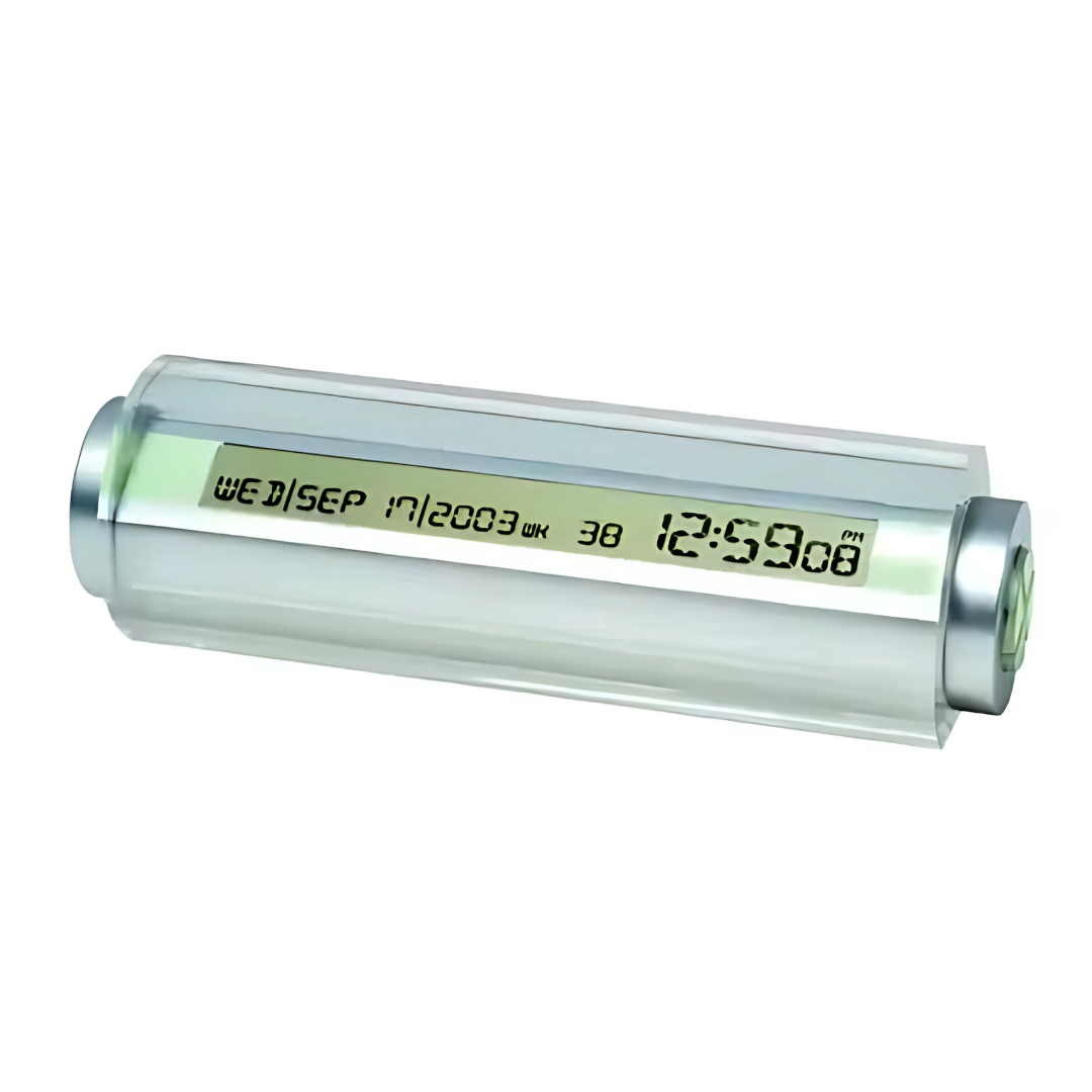 The Tube Clock is a cylindrical digital clock with a transparent case, showing the time as 12:59 PM and the date as Wednesday, September 17, 2003, against a white background.