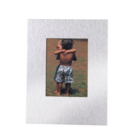 Photo of two children standing on grass, embracing and wearing shorts. The image is showcased in a sleek, brushed metal VIEW FRAME Large with a rectangular silver border that beautifully enhances the scene.