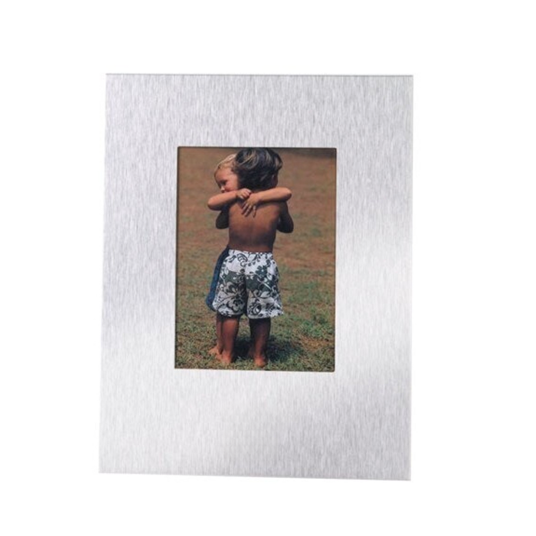 Photo of two children standing on grass, embracing and wearing shorts. The image is showcased in a sleek, brushed metal VIEW FRAME Large with a rectangular silver border that beautifully enhances the scene.