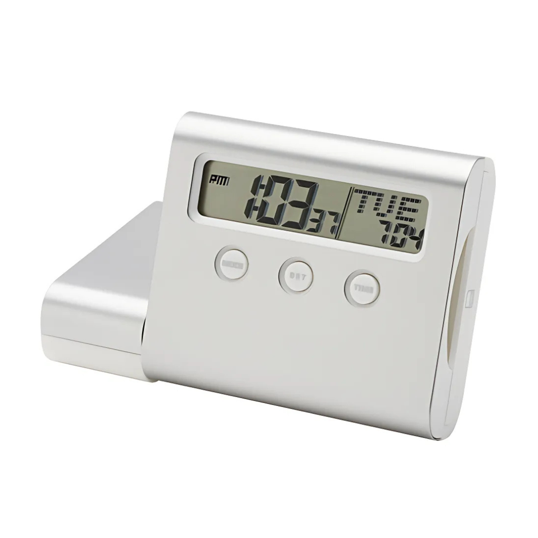 The VOYAGER CLOCK/USB HUB is a sleek silver digital alarm clock displaying 10:31 AM. It features a modern design with three function buttons and an integrated USB hub, set against a clean white background.