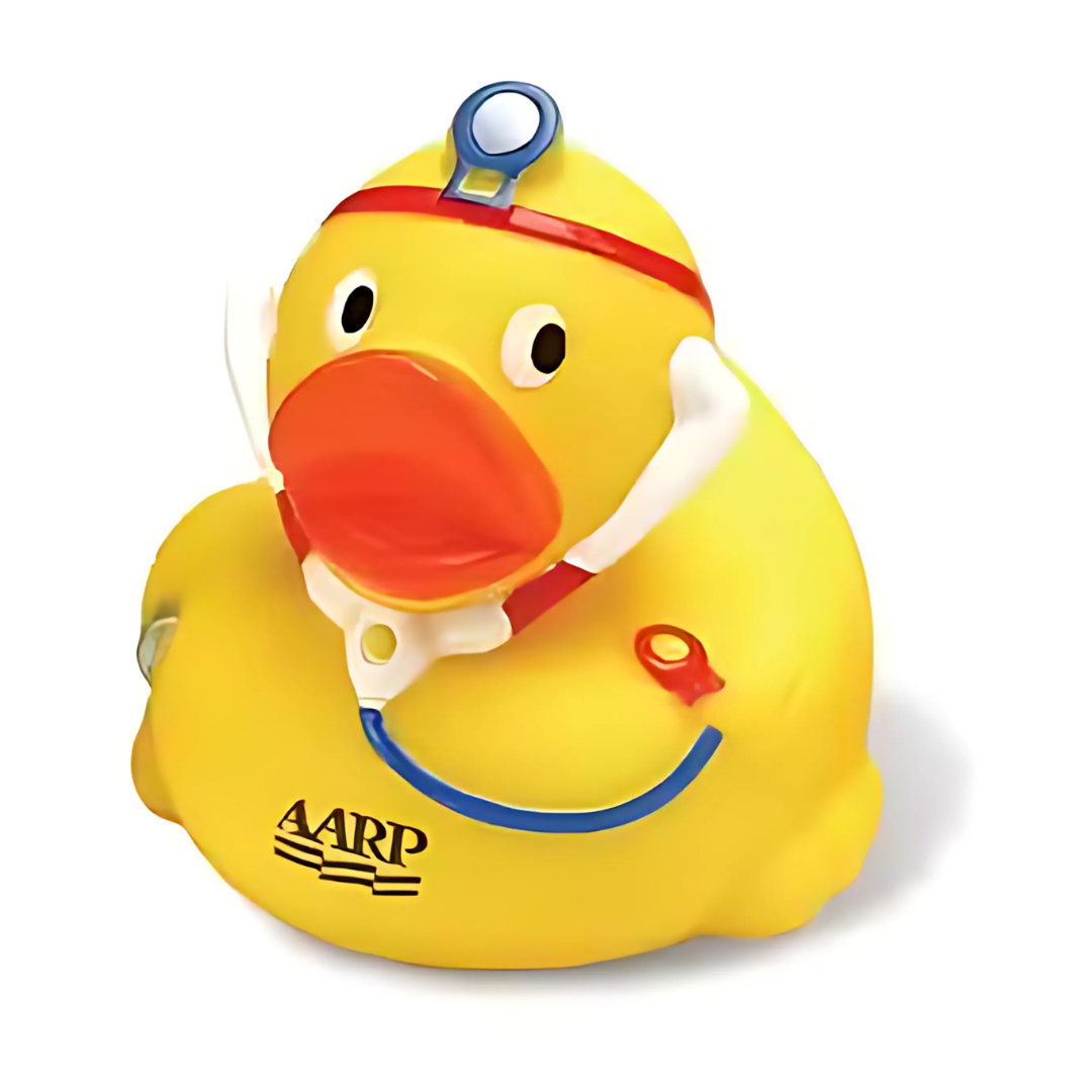 The Brandable Dr Rubber Duck, embellished with a red and blue stethoscope and an AARP logo, sports a red beak and head mirror, capturing the look of a doctor. This whimsical yellow duck against a white background is both iconic and charming.