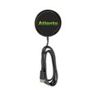A black wireless charger with the word Atlanta in green and yellow letters on the surface. A USB cable is attached, coiled neatly beneath. The charger is displayed against a plain white background.