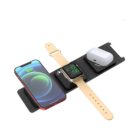 A multi-device wireless charging station displays a smartphone, smartwatch, and wireless earbuds. The smartphone is on the left, the smartwatch with a beige band is centered, and the earbuds are housed in a case on the right.